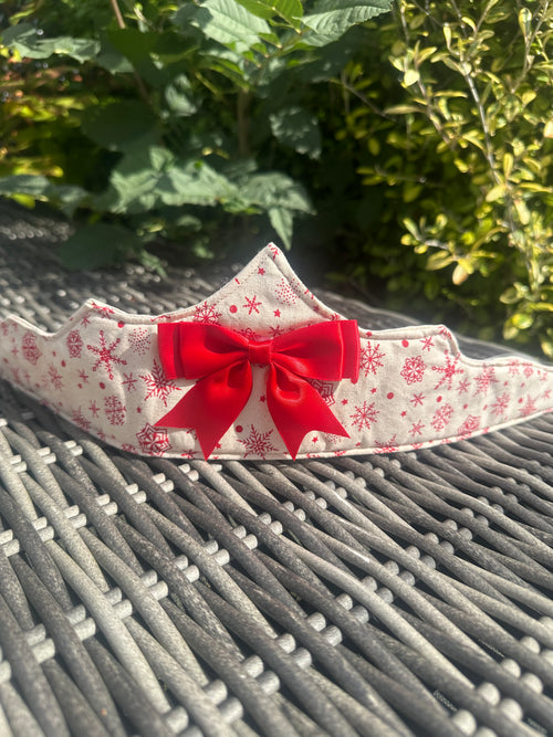 Cream fabric Christmas crown with red snowflake print and a large red bow