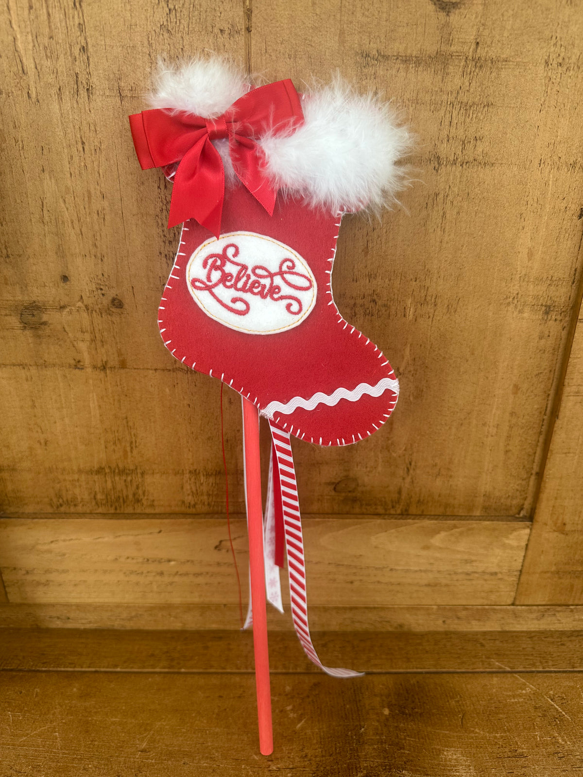 Christmas stocking wand with Believe motif, red bow, white marabou trim and striped ribbons