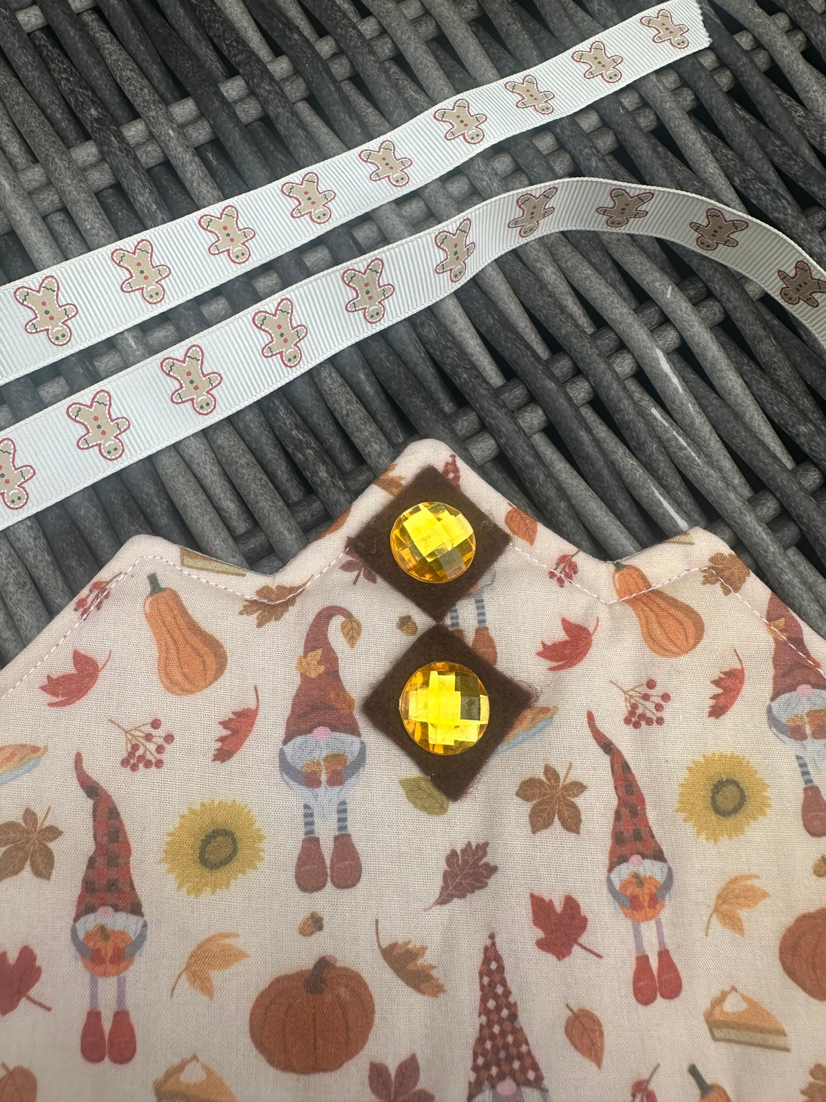 Close-up of the autumn gnome and pumpkin print crown with sparkling gem embellishments