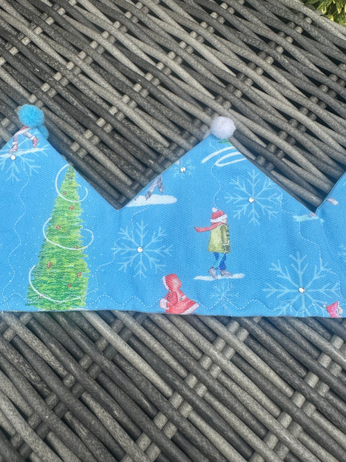 Blue fabric crown with winter skaters, Christmas tree, snowflakes and blue and white pom-poms