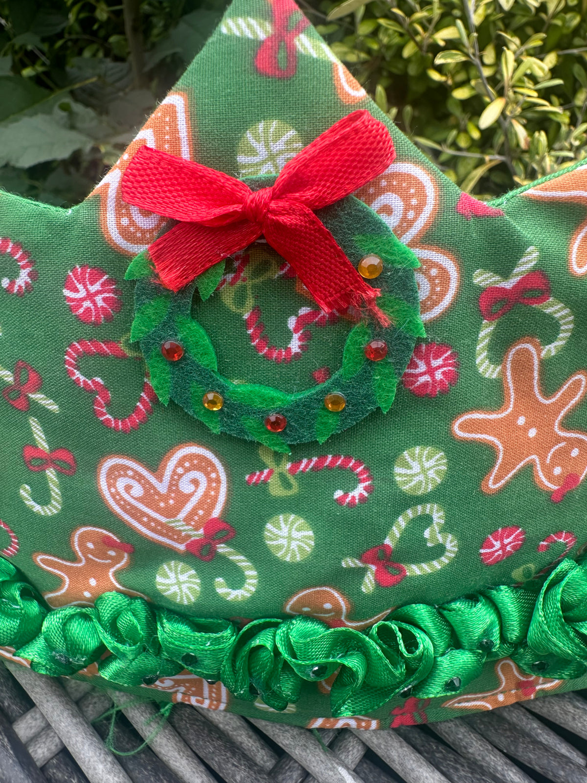Green Christmas ruffle crown with gingerbread and candy-cane print, wreath and red bow detail