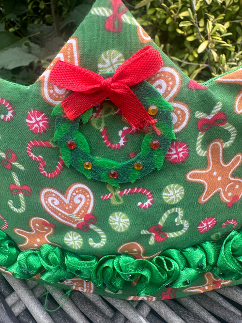 Green Christmas ruffle crown with gingerbread and candy-cane print, wreath and red bow detail