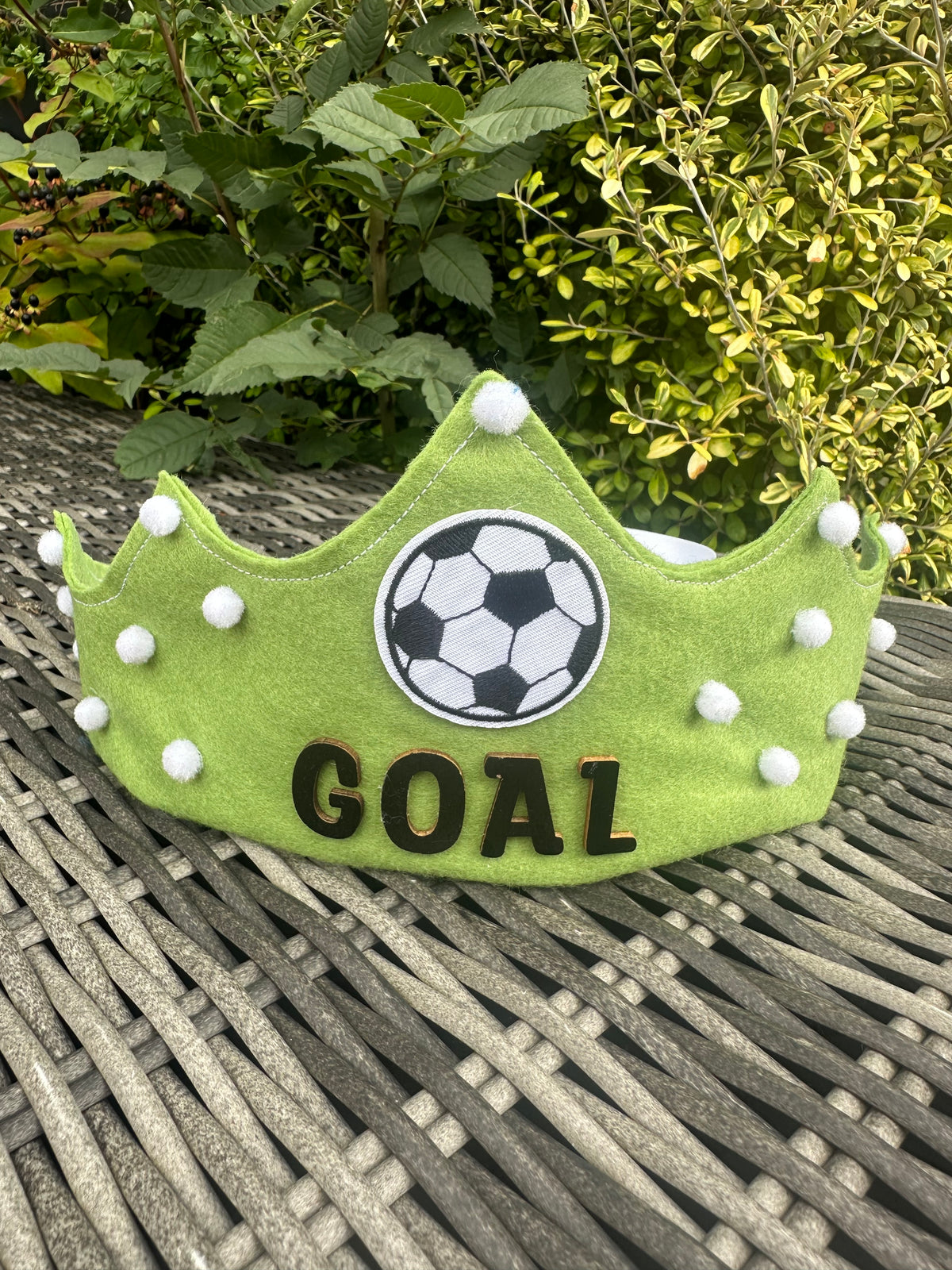 Lime green felt crown with football patch, white pompoms and GOAL lettering