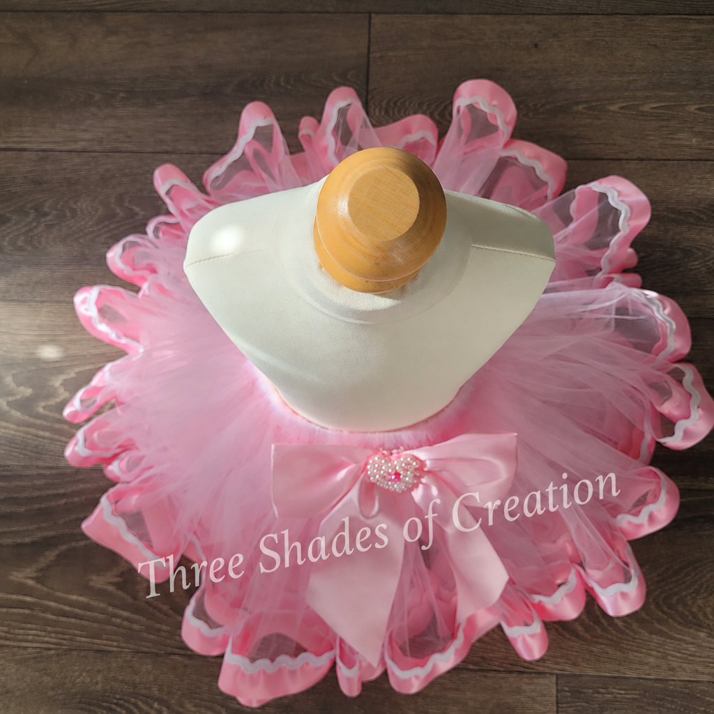 Pink ric-rac tutu overhead view with translucent Three Shades of Creation watermark