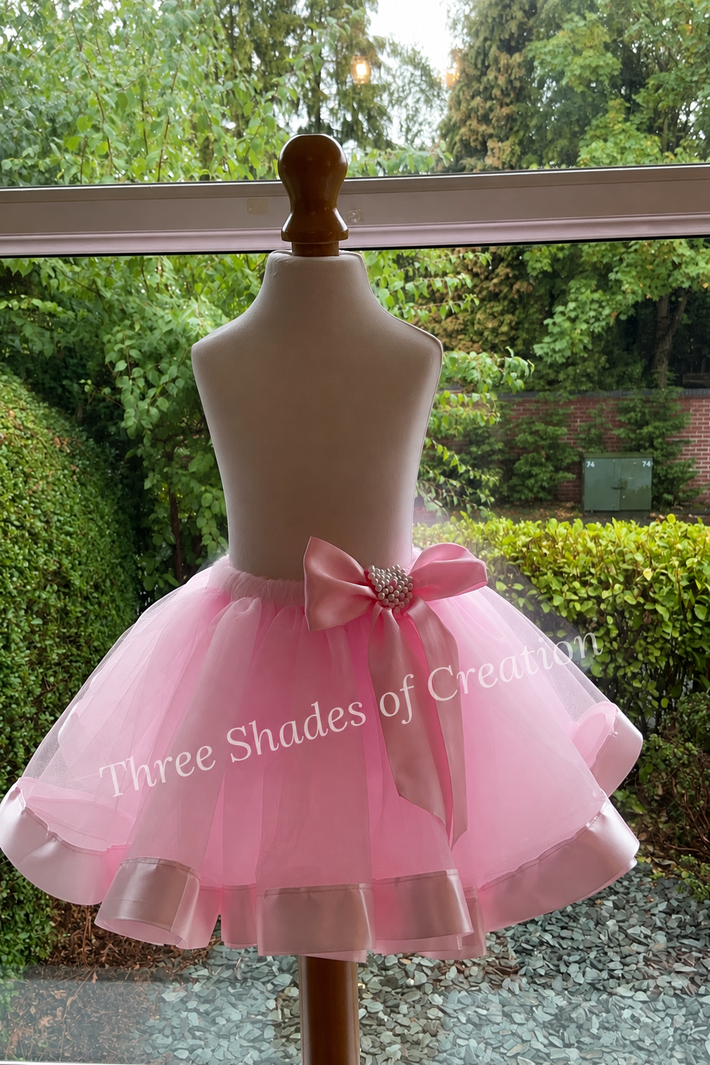 Pink Satin Bow Tutu by window with translucent Three Shades of Creation watermark