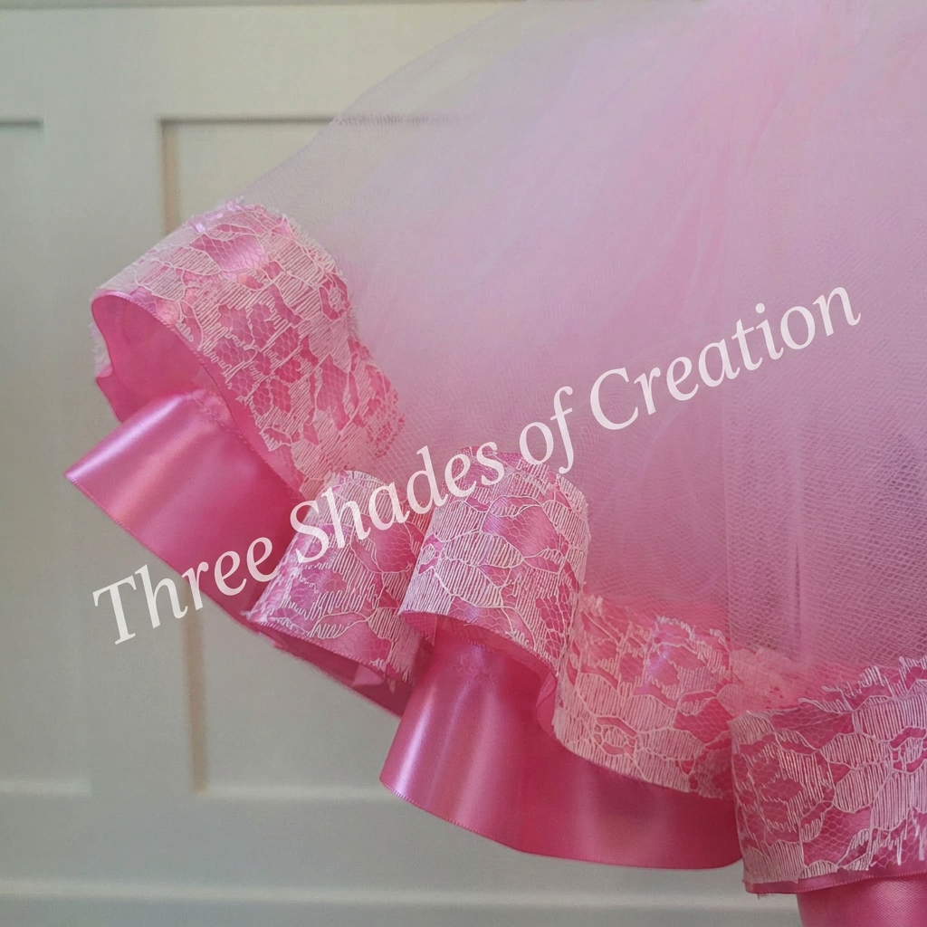 Close-up of pink floral lace and satin ribbon tutu trim