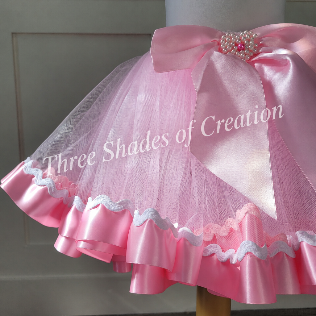 Pink tutu bow and ric-rac hem detail with translucent Three Shades of Creation watermark