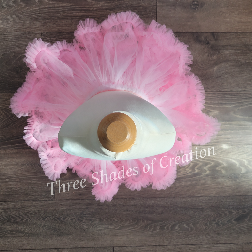 Pink ruffle tutu overhead view with translucent Three Shades of Creation watermark