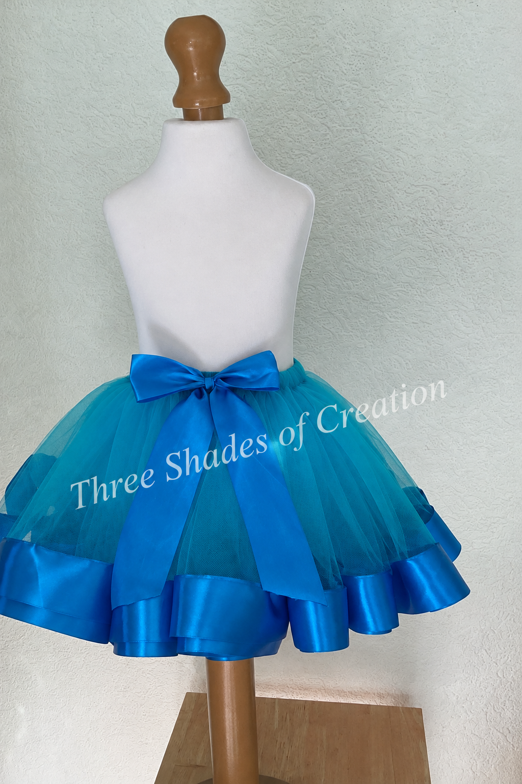 Teal and royal-blue tutu portrait view with translucent Three Shades of Creation watermark