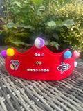 Red felt birthday crown with multicoloured pompoms, rocket patches and It's My Birthday bead lettering