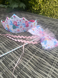 Pastel mermaid fairy crown and matching wand set on a garden table