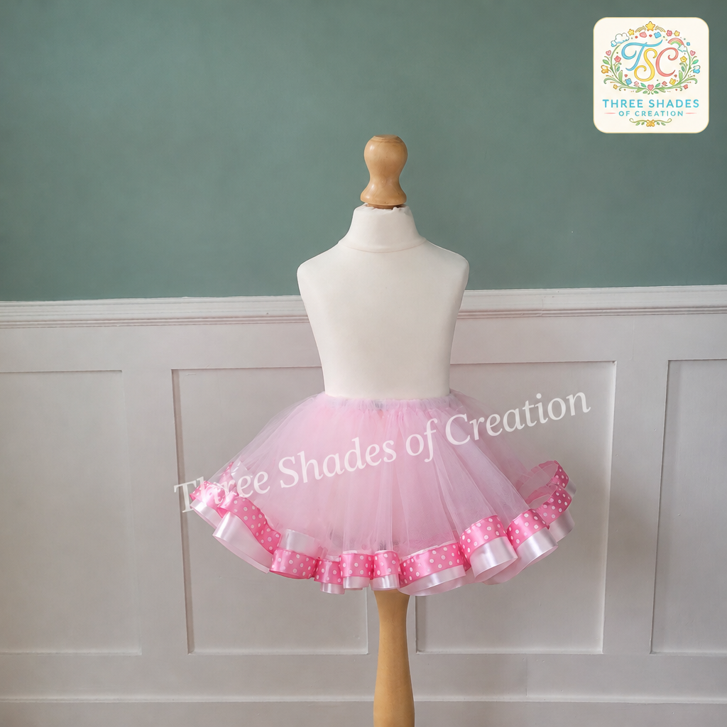 Pink polka dot ribbon tutu skirt with Three Shades of Creation logo and translucent watermark