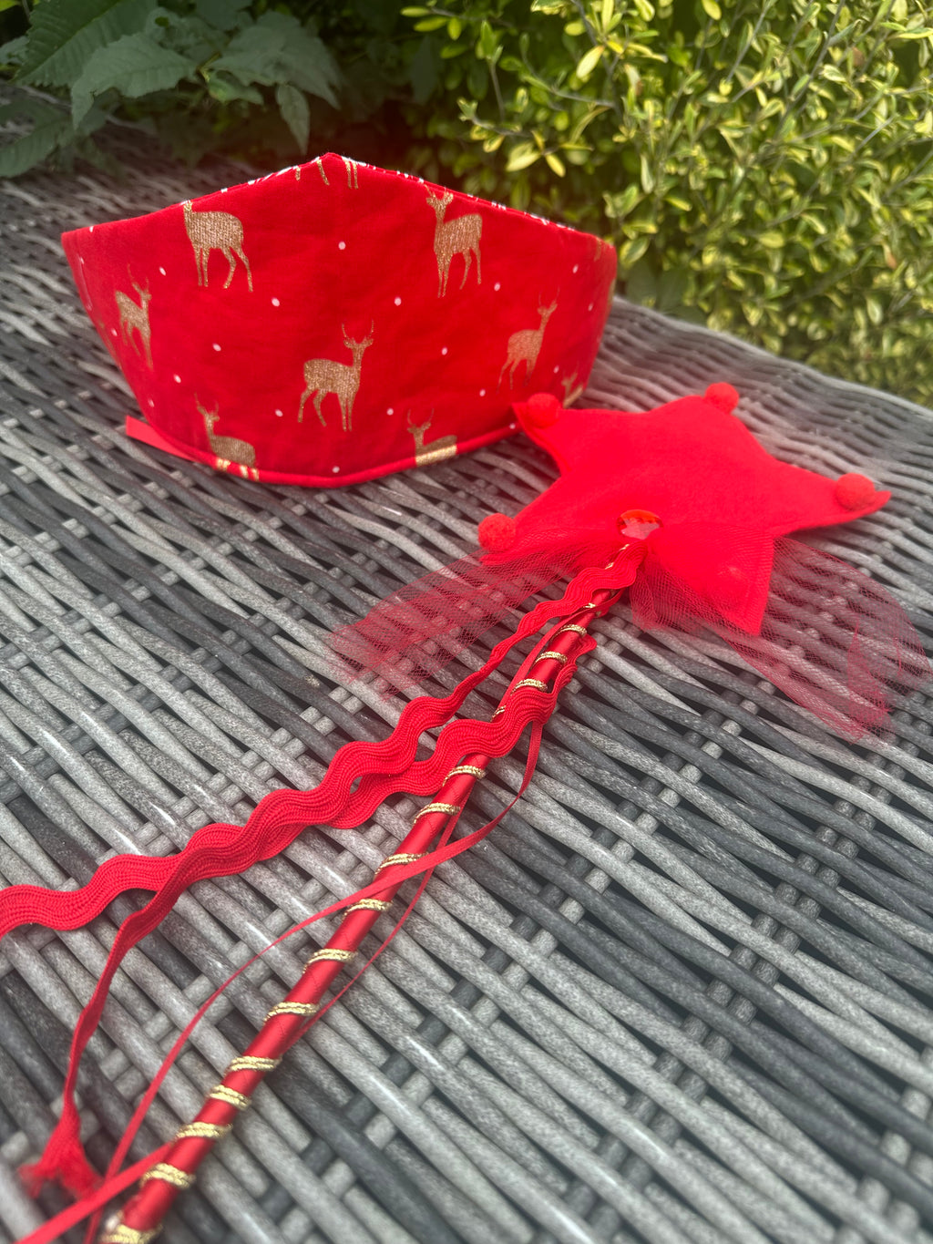 Red reindeer-print crown and matching red star wand with festive ribbon and tulle details