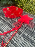 Red reindeer-print crown and matching red star wand with festive ribbon and tulle details