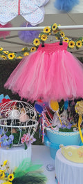 Shaded pink tutu skirt with layered tulle hanging on display