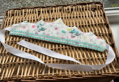 Handmade white bunny print fabric crown with teal ric-rac ribbon trim and teal sequin butterfly appliqués
