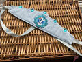 Handmade ice blue satin crown with embroidered Olaf appliqué in teal frame and large teal gem stone embellishments