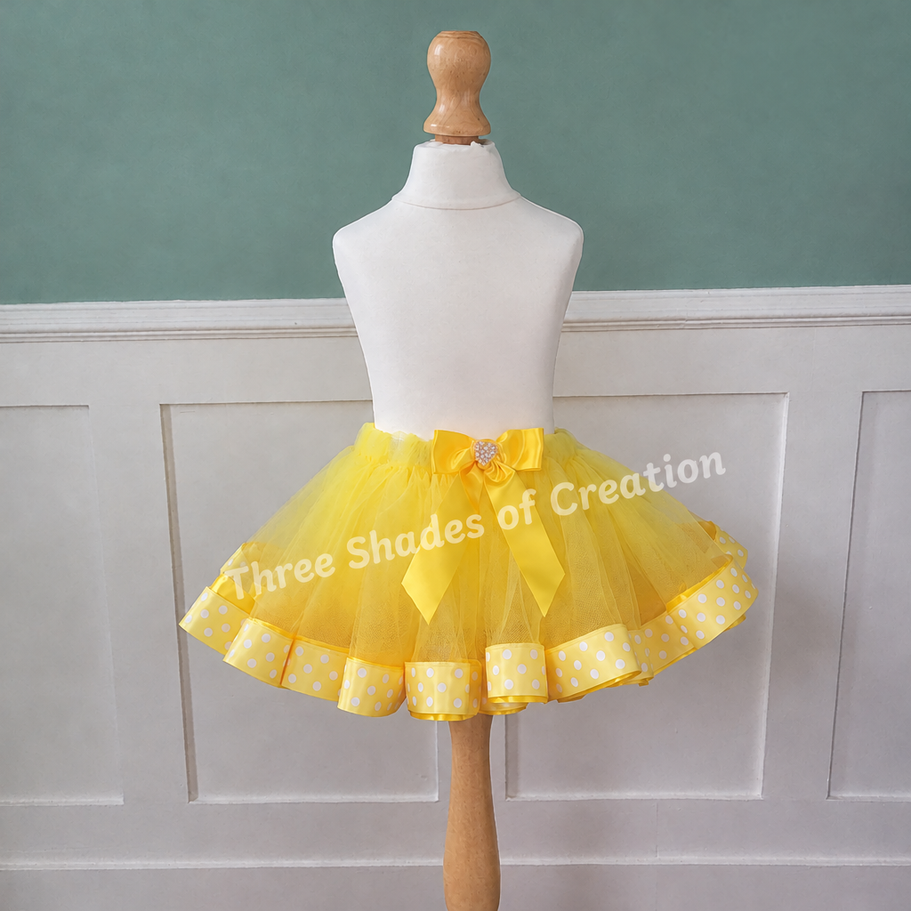 Yellow polka-dot tutu with corner logo removed